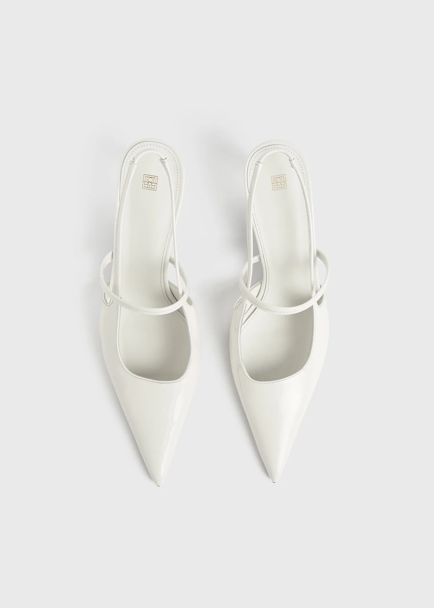 Sharp patent-leather slingbacks off white